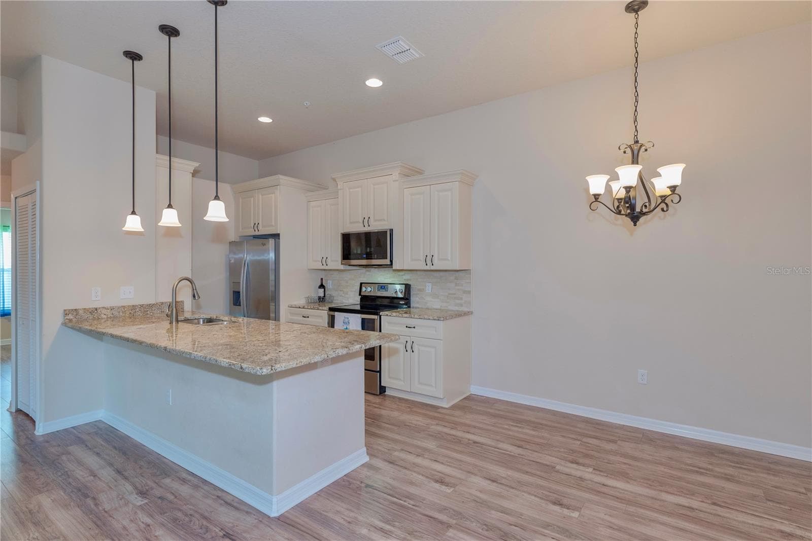 Kitchen and dining room. - 5065 ROYAL PALMS WAY #303, NEW PORT RICHEY
