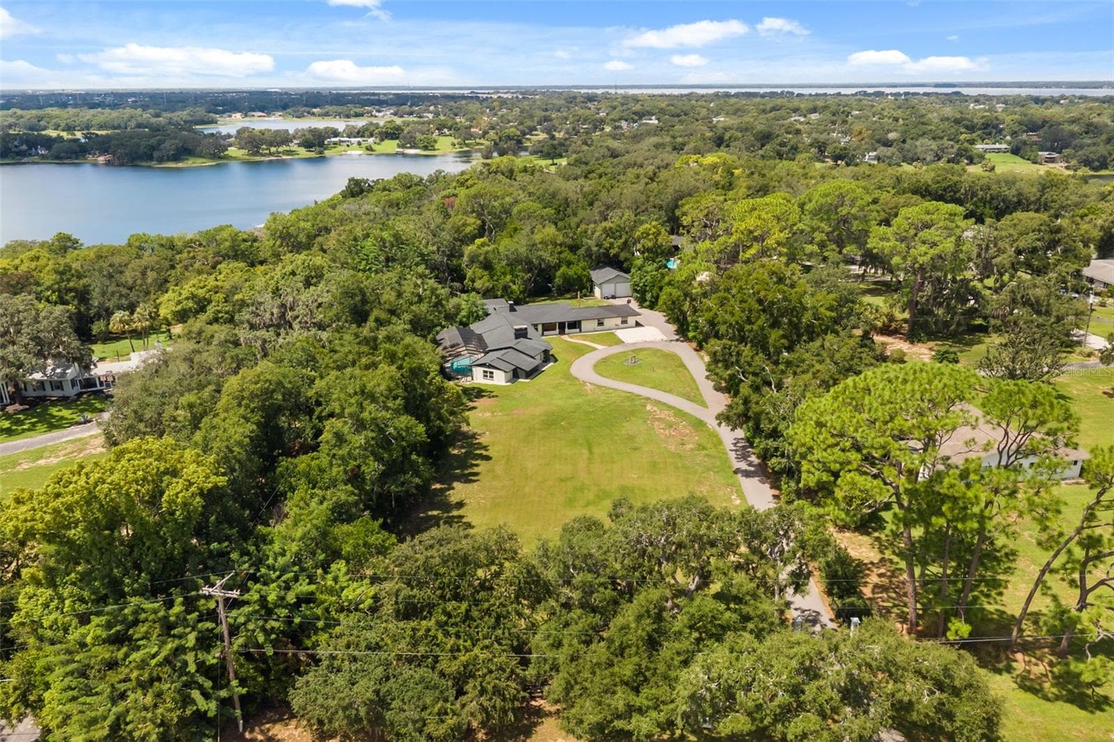 Aerial of property with East Crooked Lake in view - 1602 COUNTRY CLUB RD, EUSTIS
