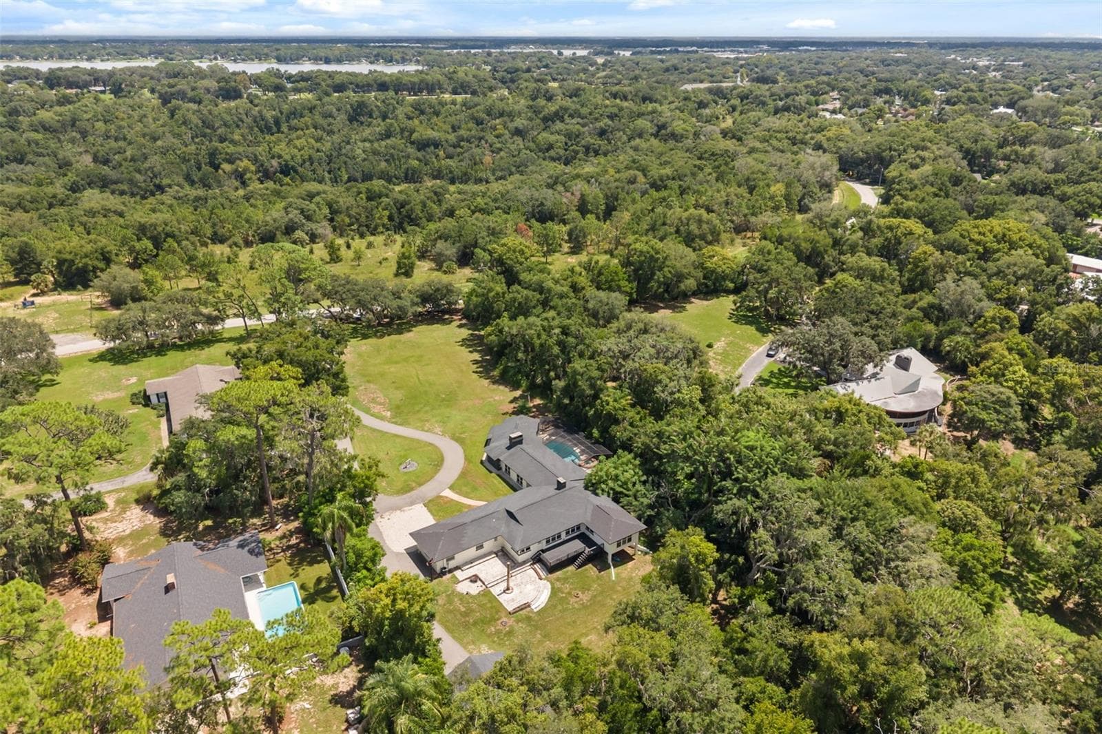Aerial from back of property with several nearby lakes in view - 1602 COUNTRY CLUB RD, EUSTIS
