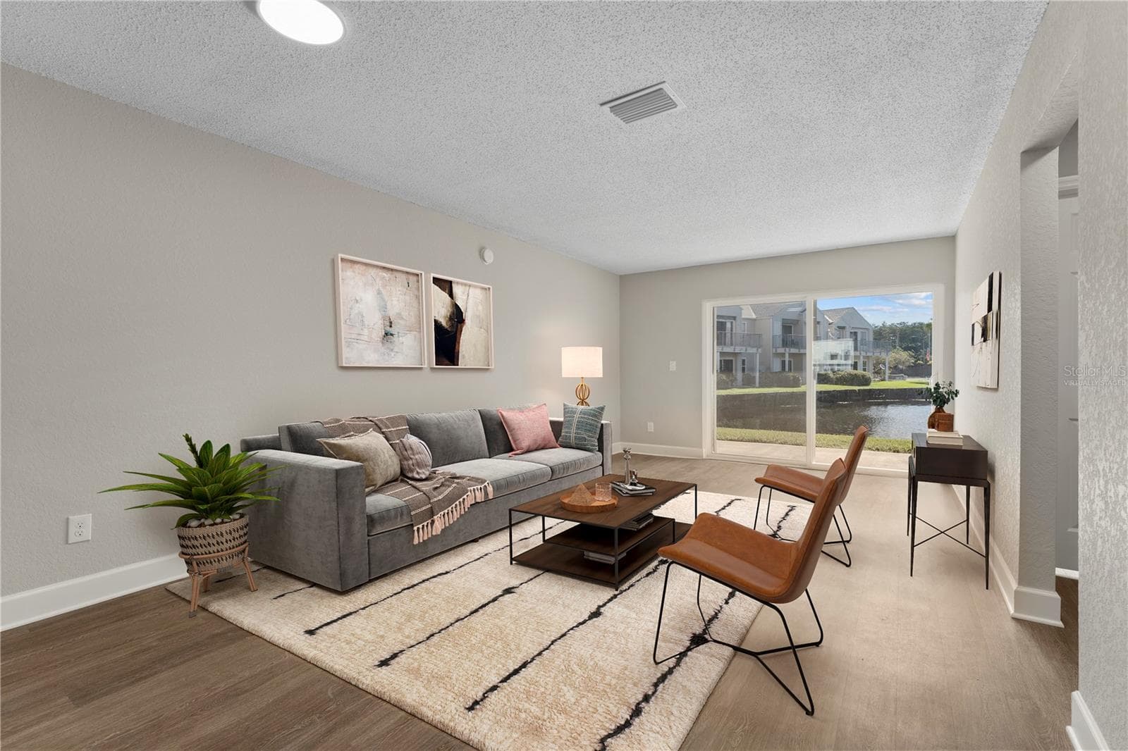 Great Room (Living + Dining) (Virtually Staged) - 2508 WOODGATE BLVD #105, ORLANDO