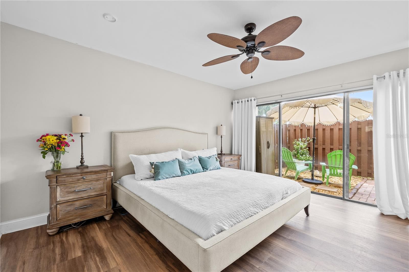 Roomy primary bedroom with plenty of room for a king bed and more, with sliders to your private backyard patio - 782 VILLAGE LAKE TER N #103, ST PETERSBURG