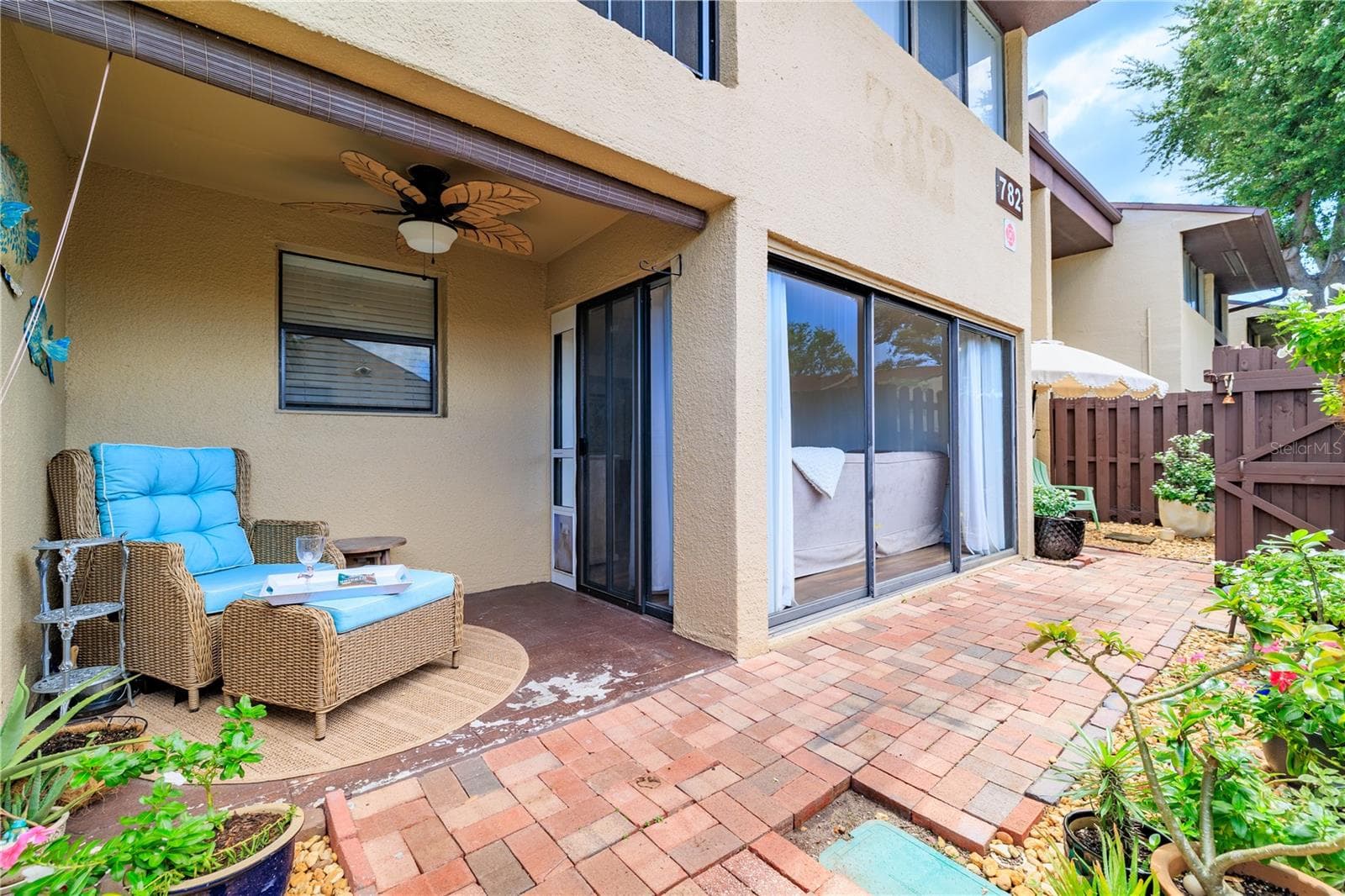 Enjoy the sunshine on your covered pavered patio - 782 VILLAGE LAKE TER N #103, ST PETERSBURG
