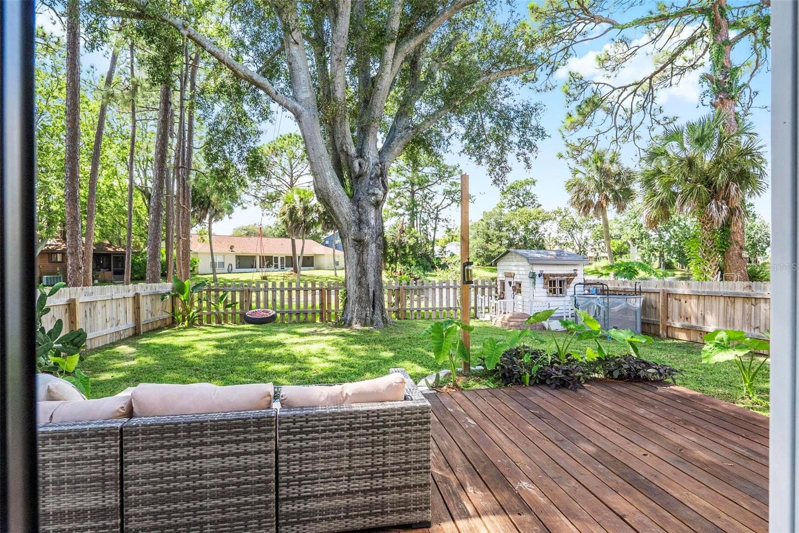 Backyard with decking & tons of shade - 1110 MONTICELLO LN #1, PORT ORANGE
