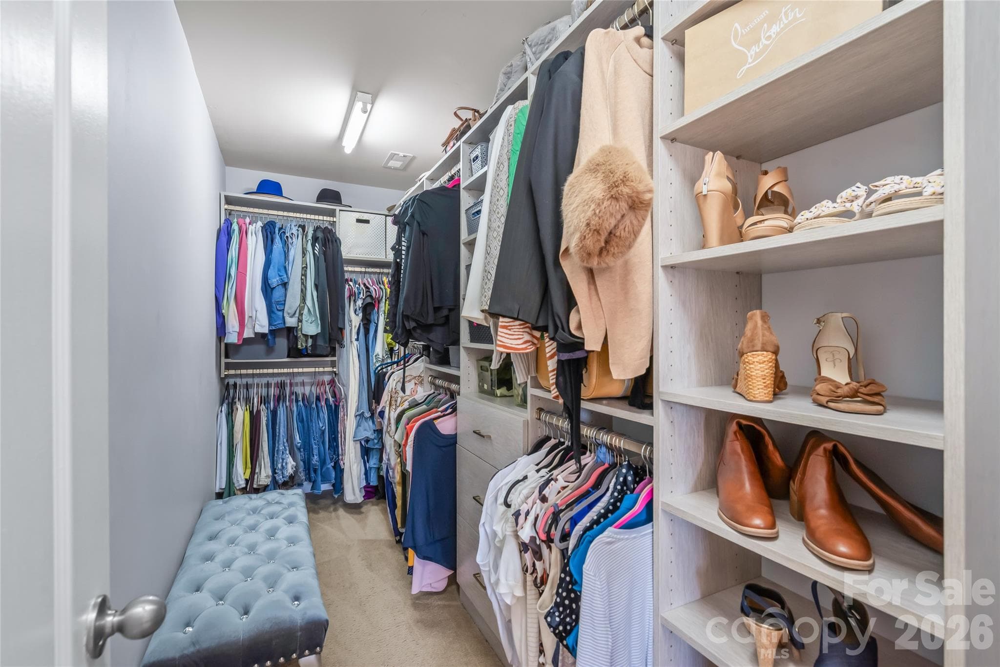 "The custom primary walk-in closet is designed like a high-end dressing room, featuring thoughtful open shelving that makes it easy to see your entire wardrobe and plan outfits without feeling rushed." - 6404 Lanzerac Manor Drive, Charlotte