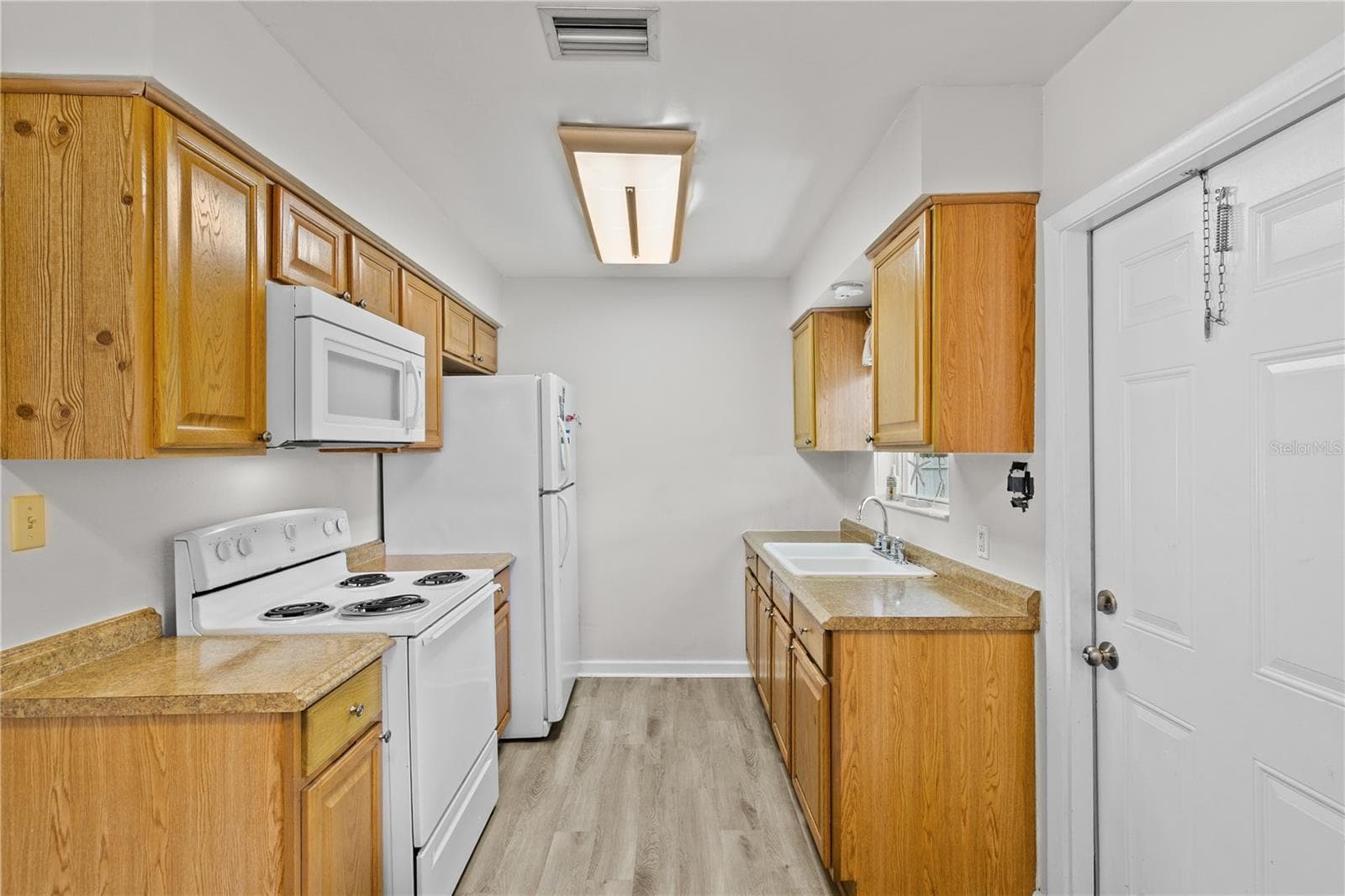 Kitchen with Outdoor Patio Access - 930 ALFORD ST, TITUSVILLE