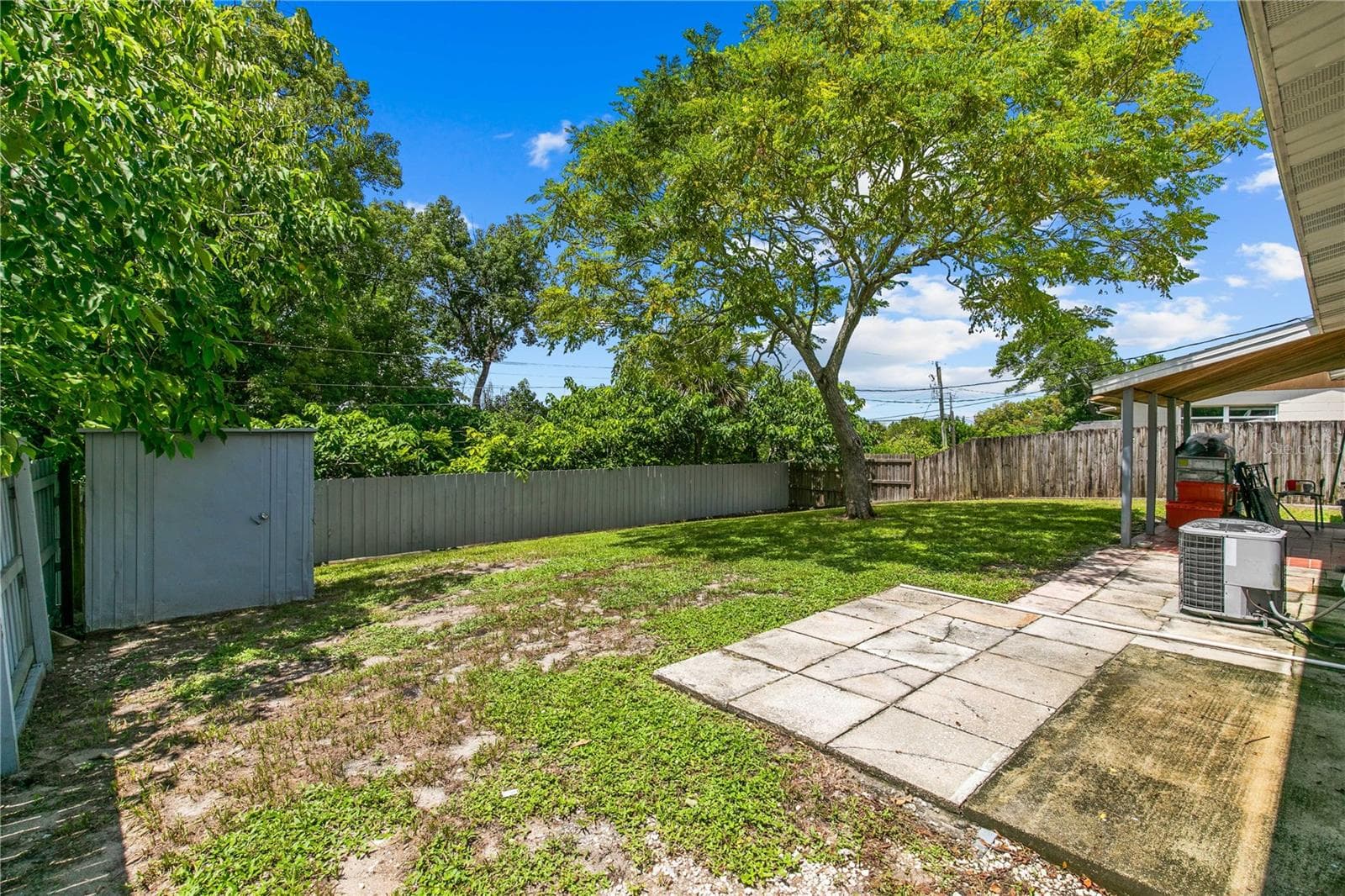 Fenced Backyard Overlooking Shed and Mature Trees - 930 ALFORD ST, TITUSVILLE