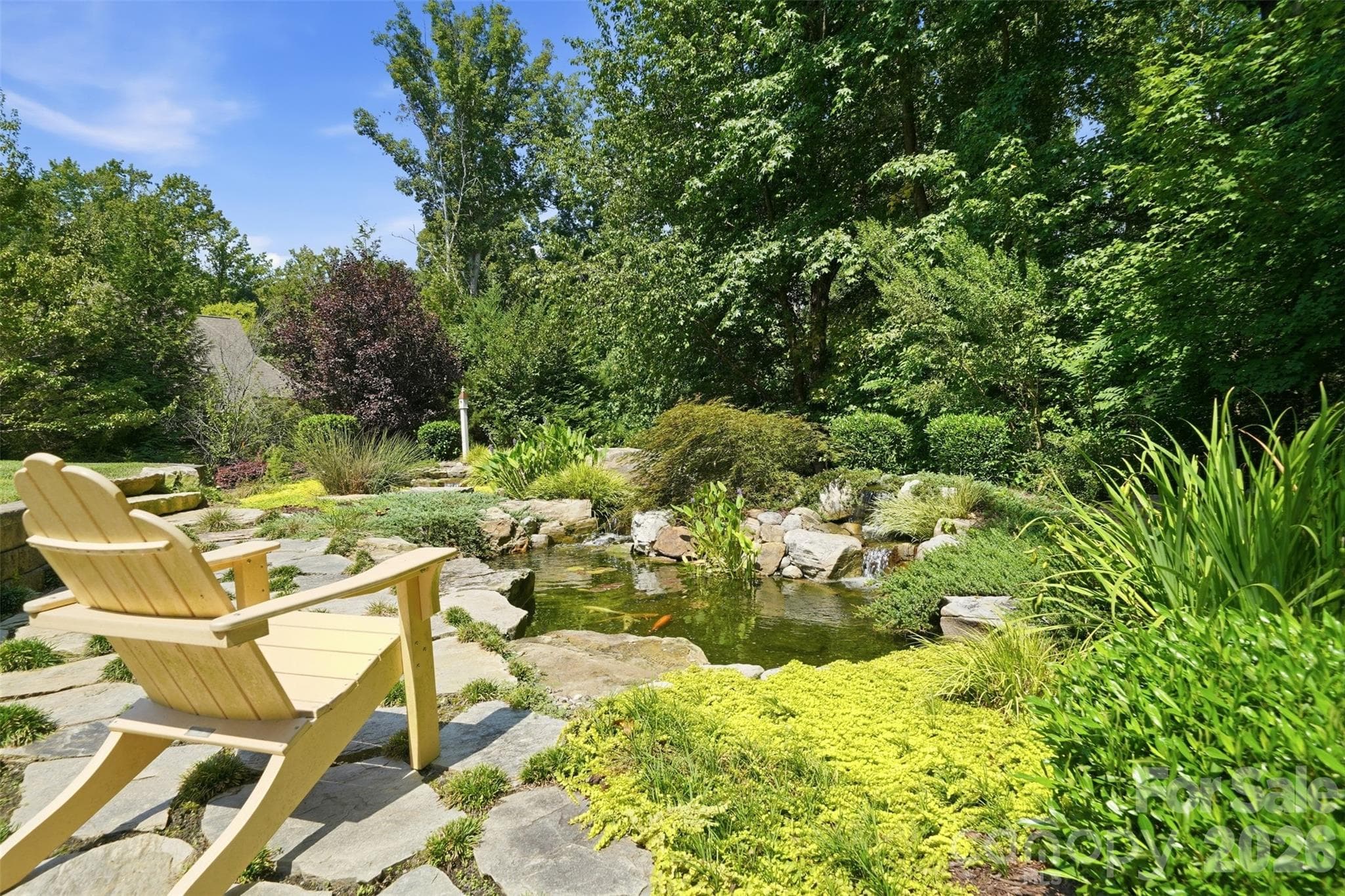 Backyard featuring Water Feature w/ Koi pond & wooded privacy - 1206 Delaney Drive, Weddington