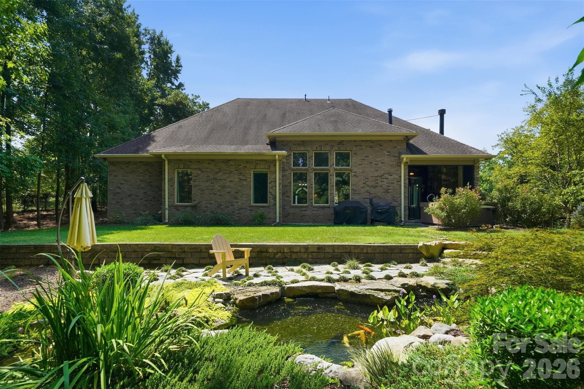 Backyard featuring Water Feature w/ Koi pond & wooded privacy - 1206 Delaney Drive, Weddington
