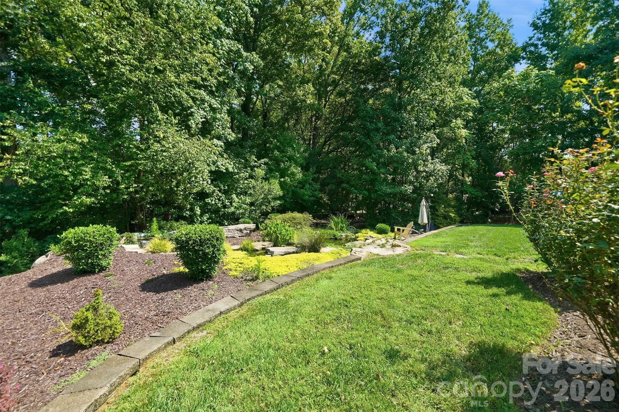 Backyard featuring Water Feature w/ Koi pond & wooded privacy - 1206 Delaney Drive, Weddington