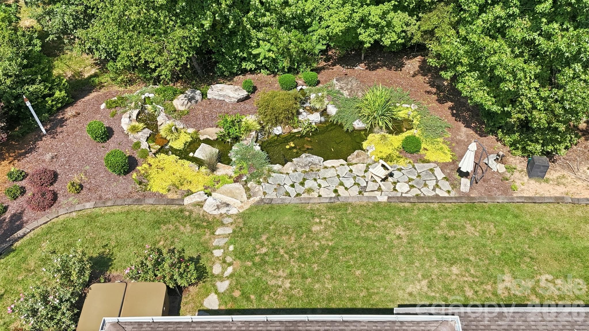 Backyard featuring Water Feature w/ Koi pond & wooded privacy - 1206 Delaney Drive, Weddington
