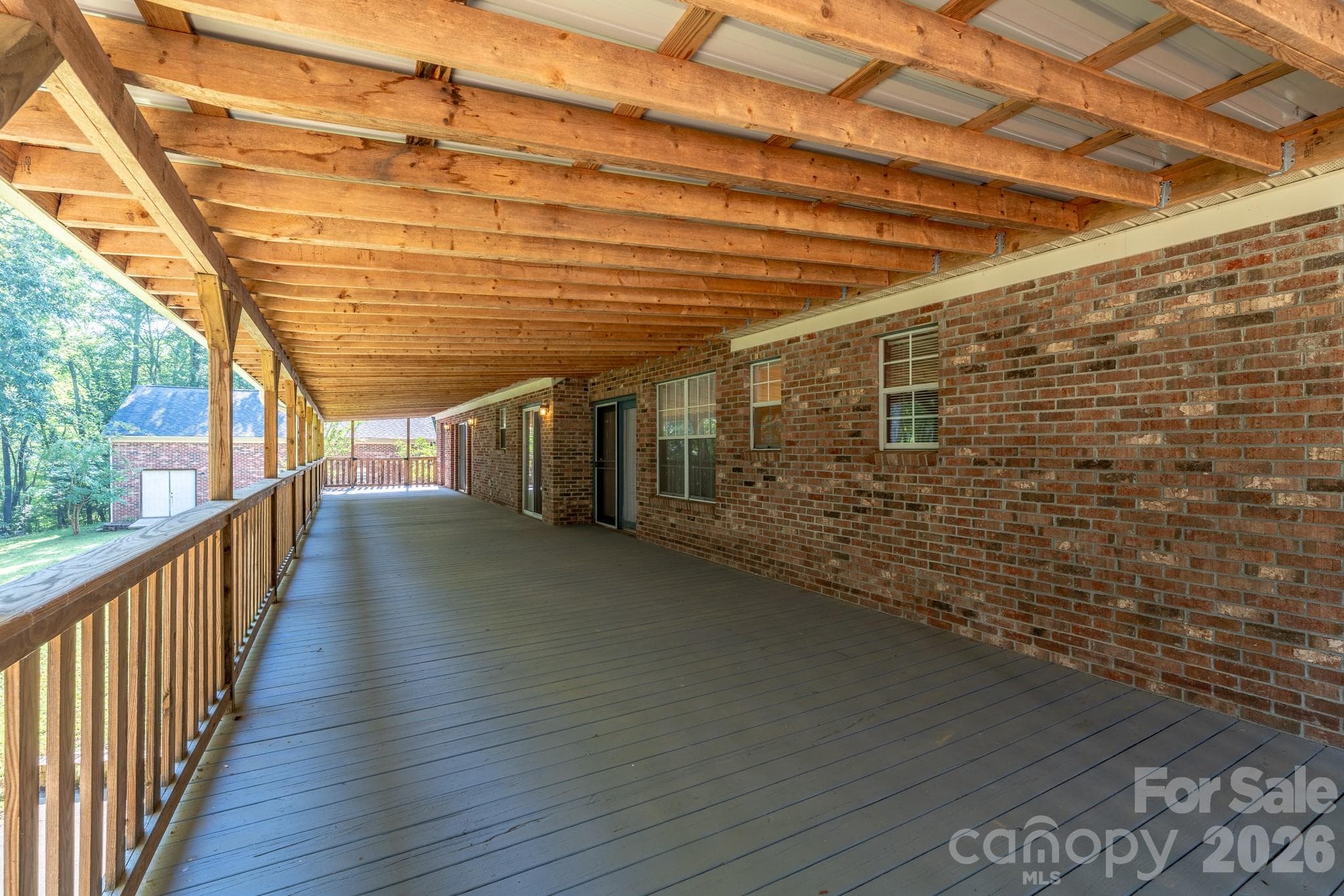So much room on the covered back porch! Think of all the entertaining! - 1886 Tanasee Gap Road, Balsam Grove