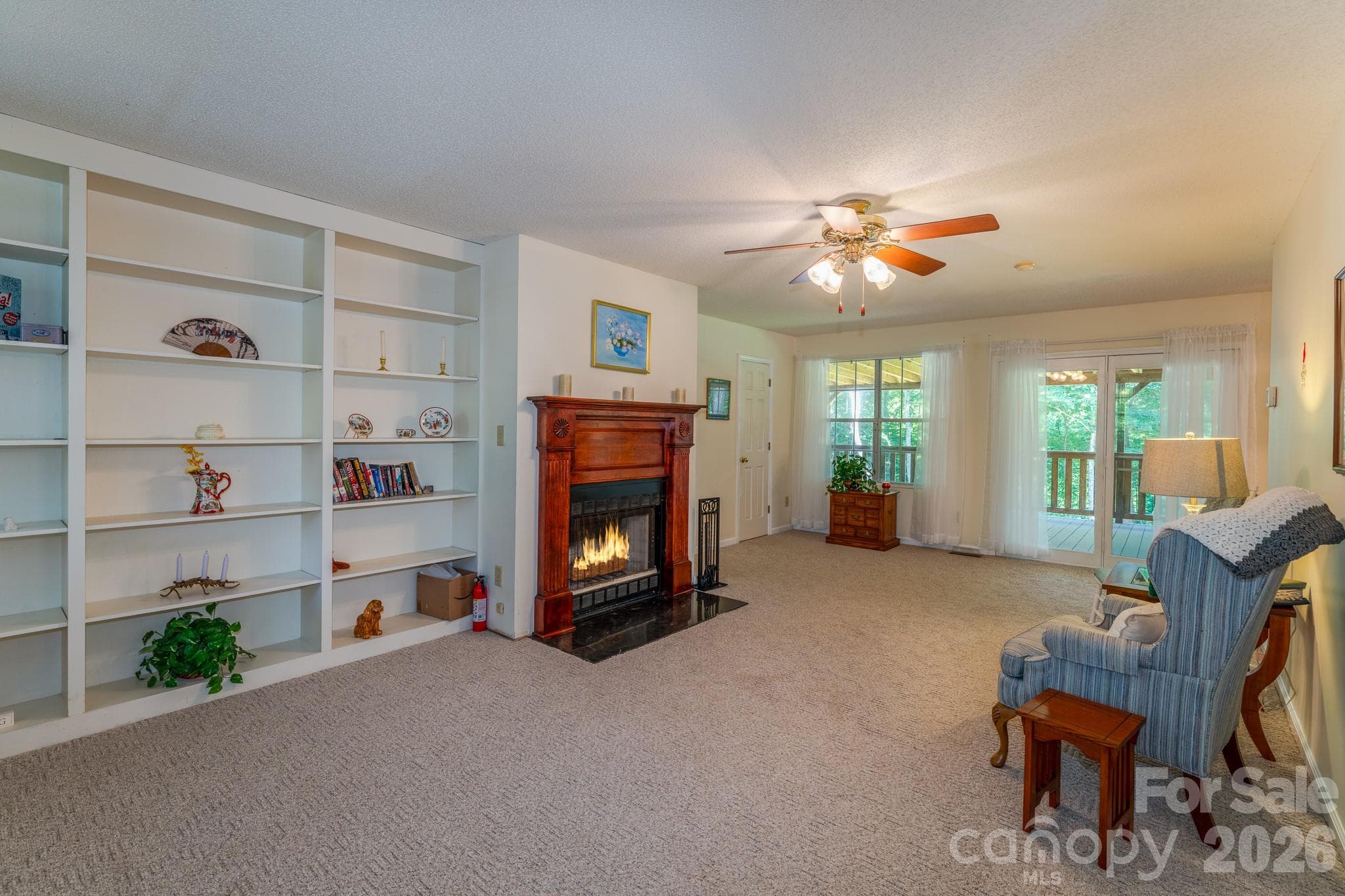 A cozy living room with a wood burning fireplace! - 1886 Tanasee Gap Road, Balsam Grove