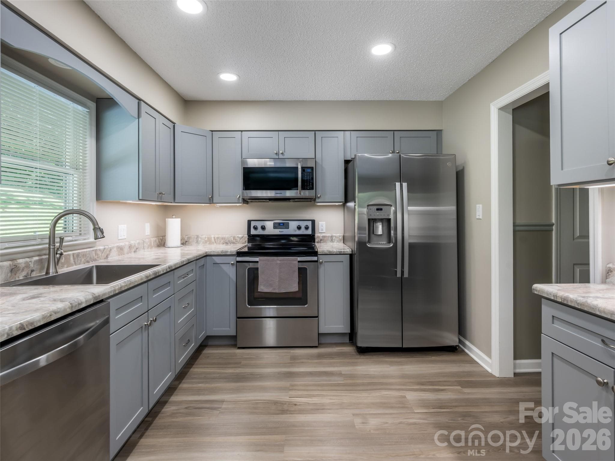 Flowing into the wide hallway with convenient half bath. - 1 Morris Drive, Weaverville
