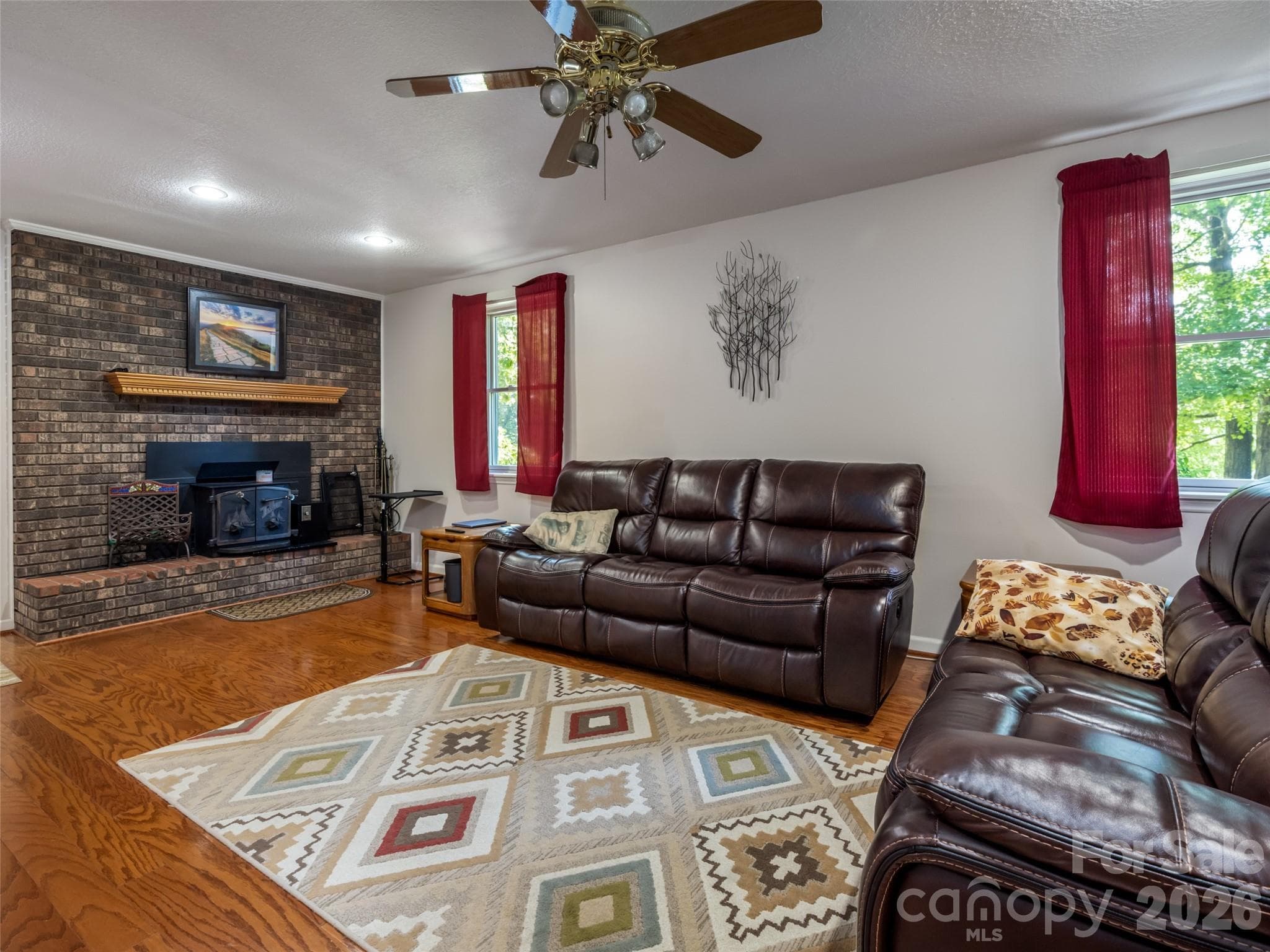 Cozy family room featuring a wood stove. - 1 Morris Drive, Weaverville