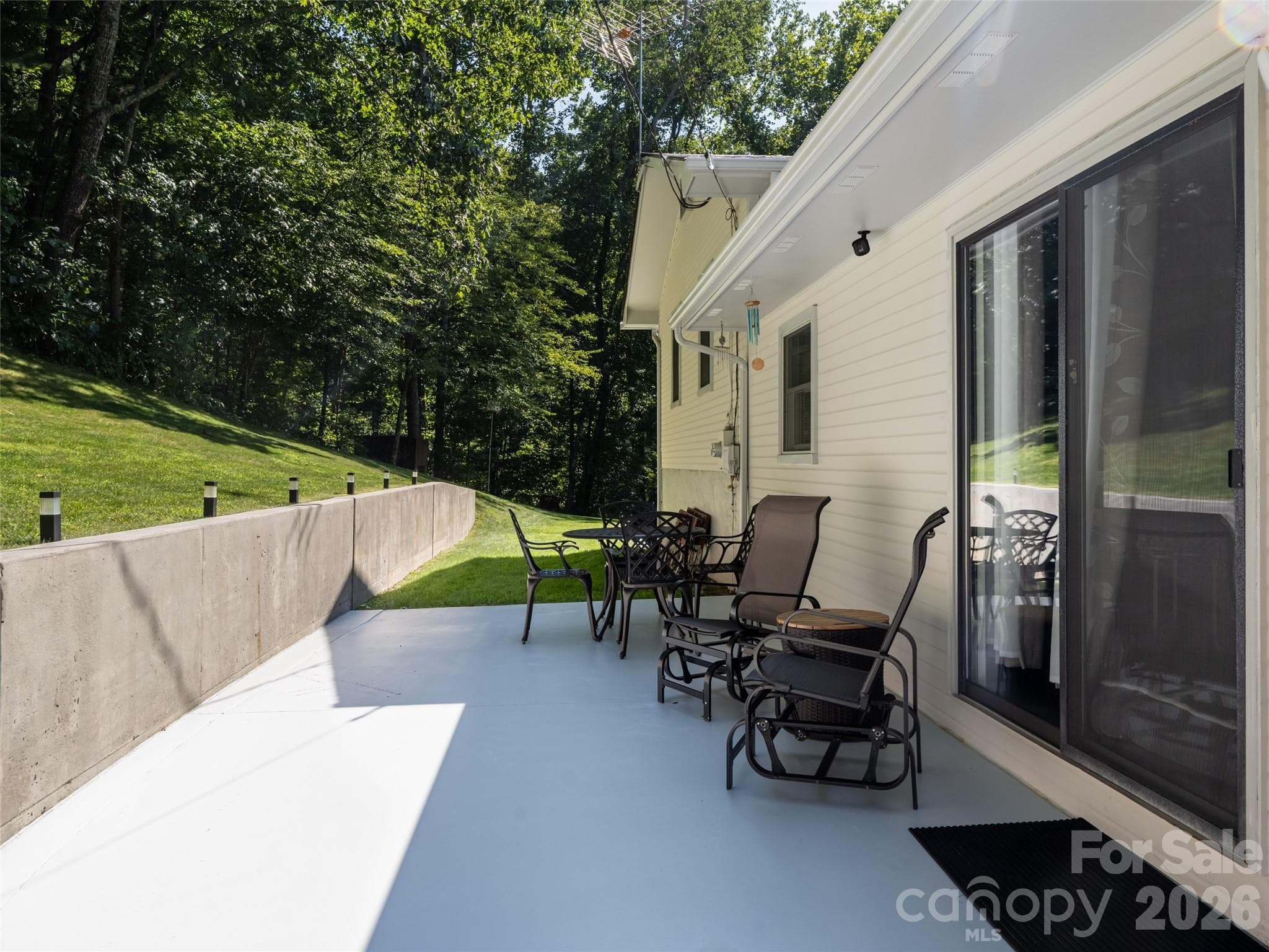 New private patio overlooking the woods, and solid-concrete retaining wall. - 1 Morris Drive, Weaverville