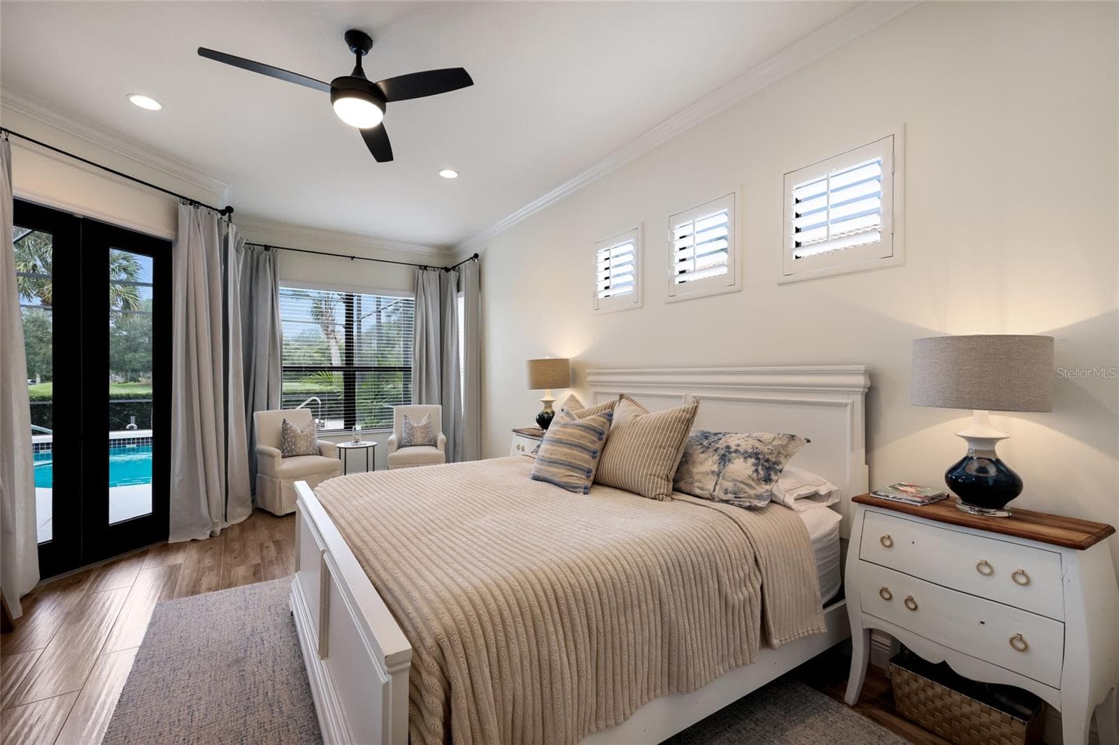 Sitting area and slider access to lanai from primary suite - 13994 SIENA LOOP, LAKEWOOD RANCH