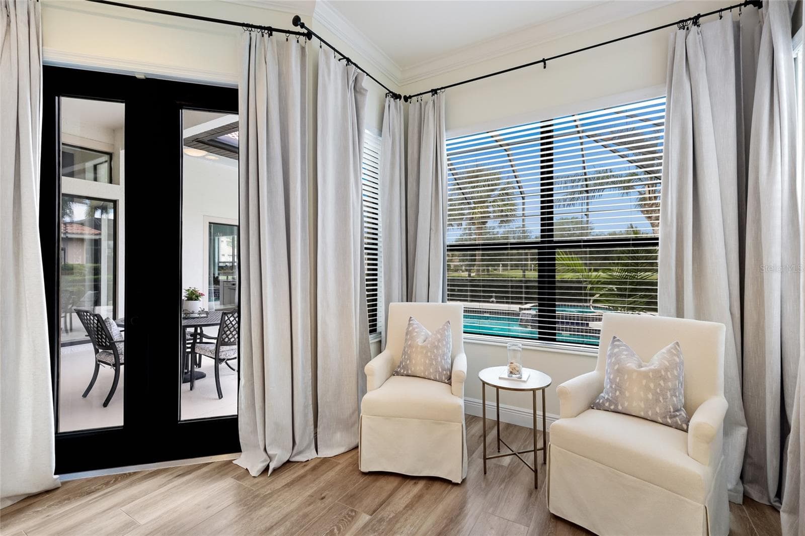 Sitting area and slider access to lanai from primary suite - 13994 SIENA LOOP, LAKEWOOD RANCH