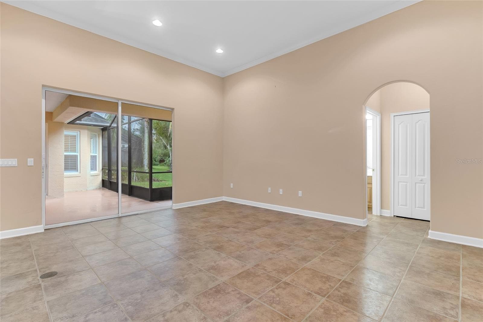 Family Room. Bathroom 3 & Bedroom 4 to the Right, Screened in Patio to the Left. - 2672 ALOMA OAKS DR, OVIEDO