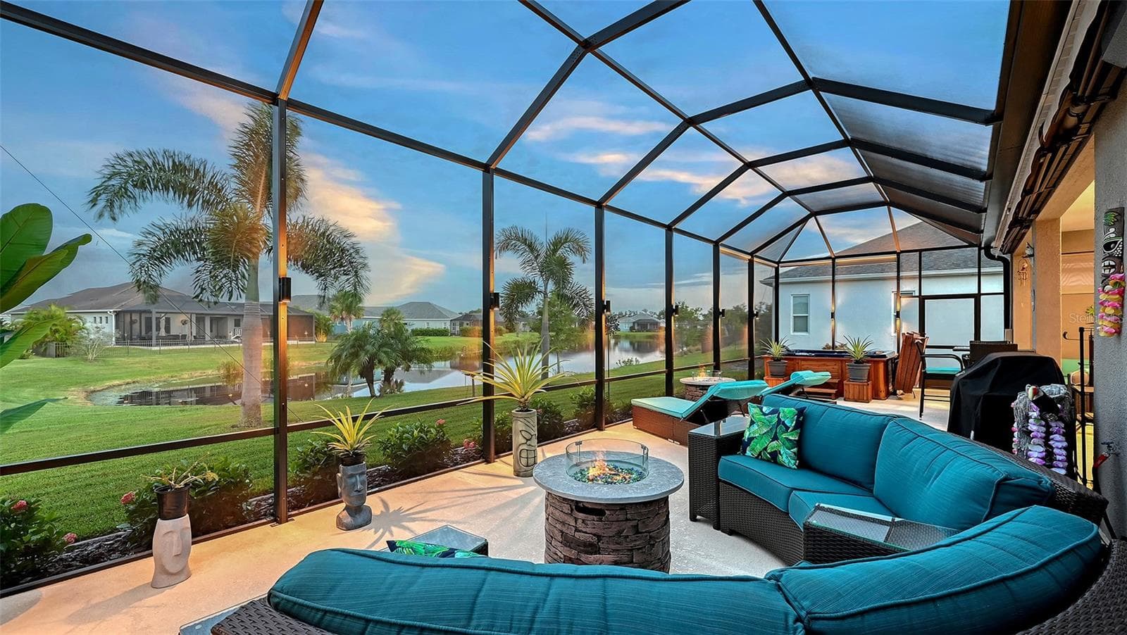 Outdoor entertaining area with pond views - awnings retracted - 13667 OLD CREEK CT, PARRISH