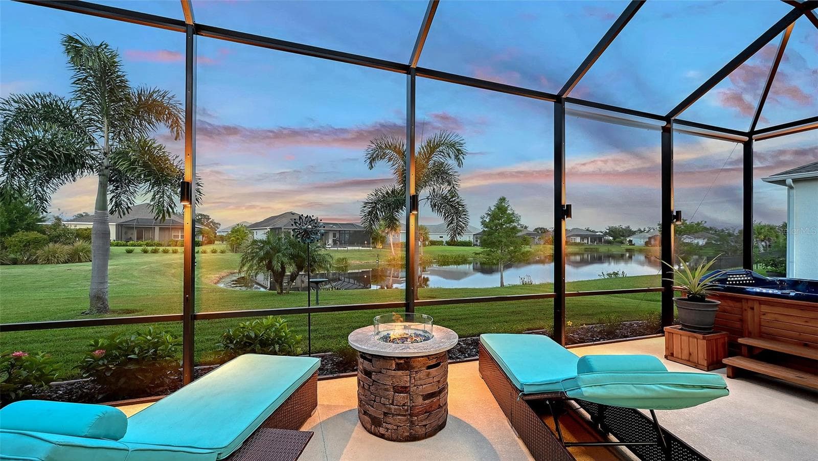 Outdoor lounge area with pond view - 13667 OLD CREEK CT, PARRISH