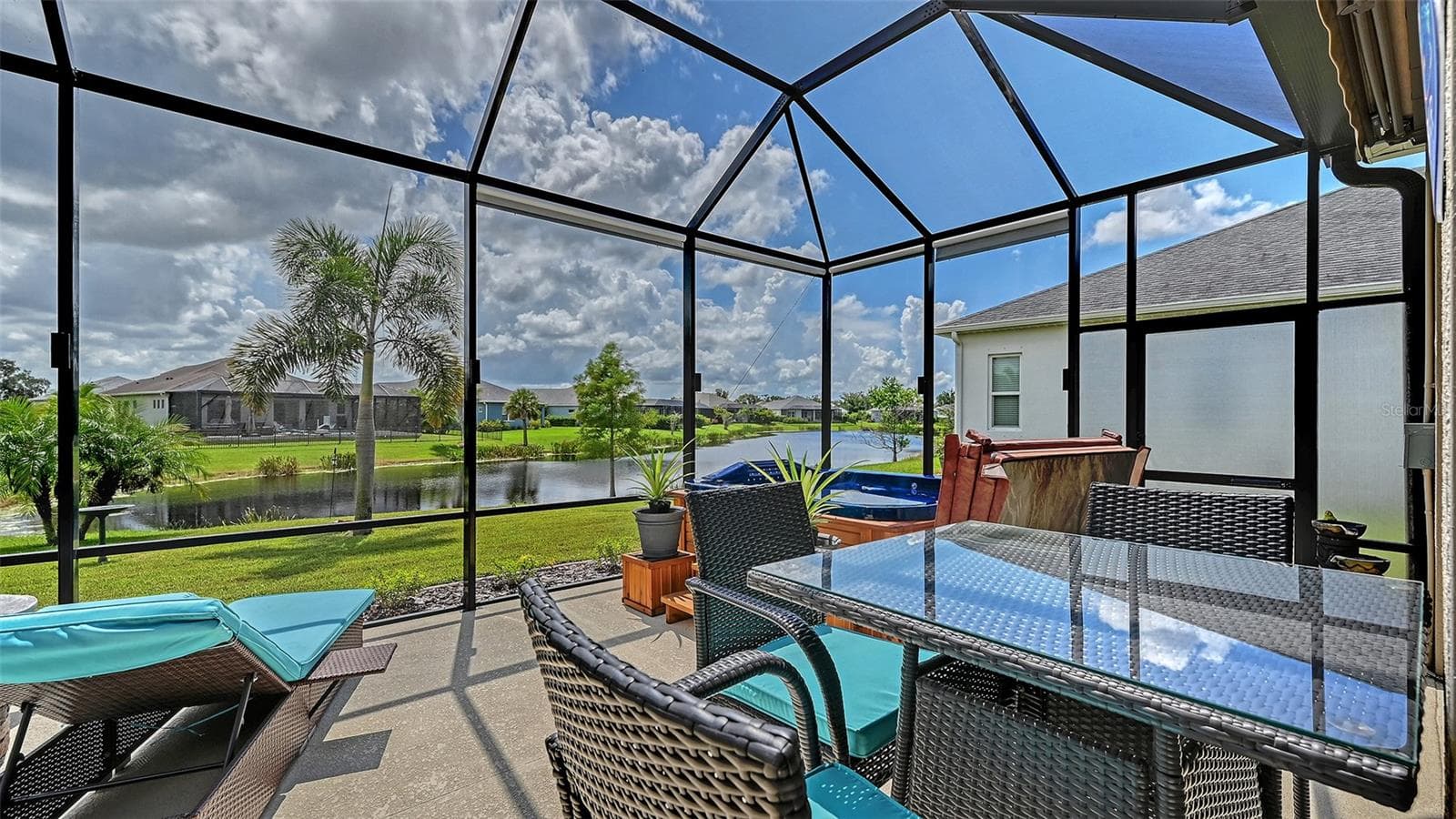 Outdoor entertaining area with pond views - 13667 OLD CREEK CT, PARRISH