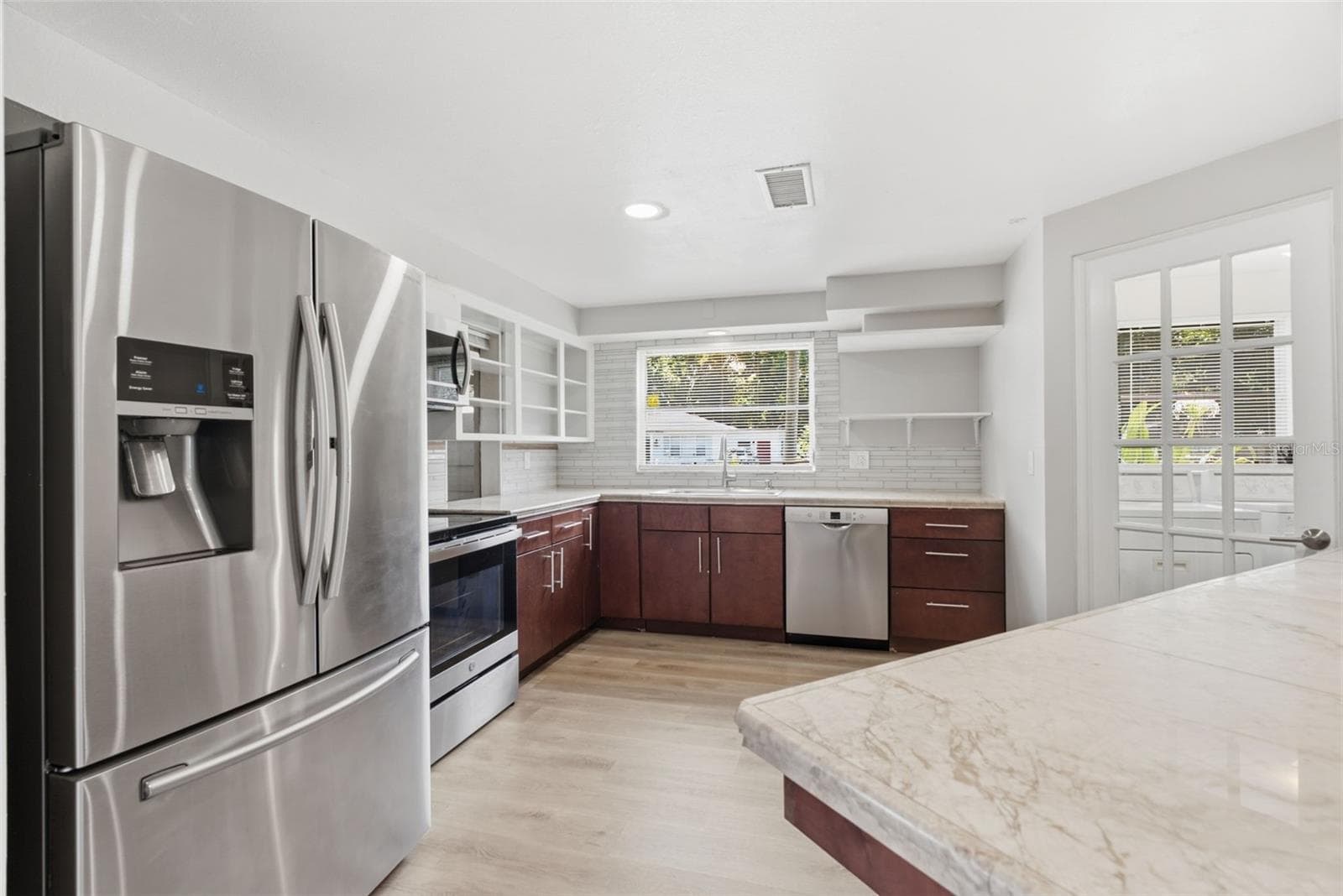 Spacious kitchen with open shelving - 6701 13TH ST N, TAMPA