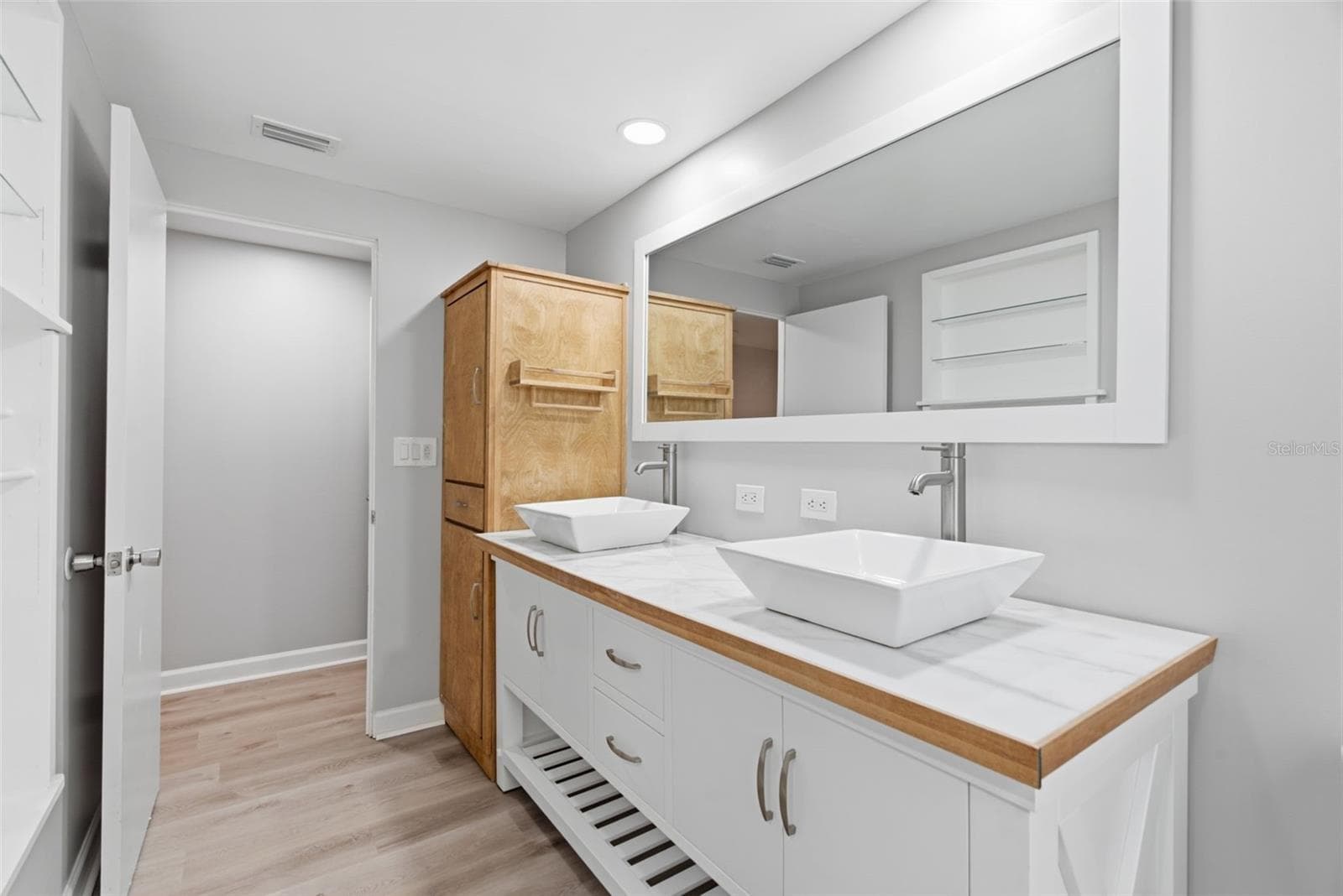 Primary bath, dual sinks, storage cabinet - 6701 13TH ST N, TAMPA