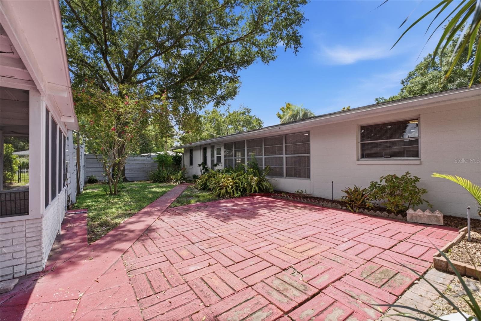 Shaded yard with brick patio - 6701 13TH ST N, TAMPA