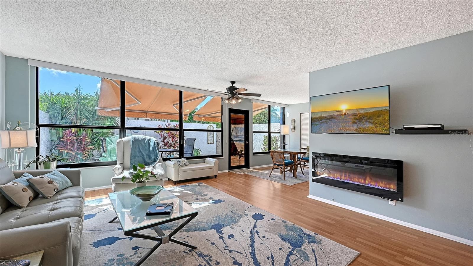 Living room with a peak around the cornet into what was the lanai section behind master bedroom. Area can be screened off with a folding blind for crafts area or office. - 666 WOODLAWN DR #666, BRADENTON