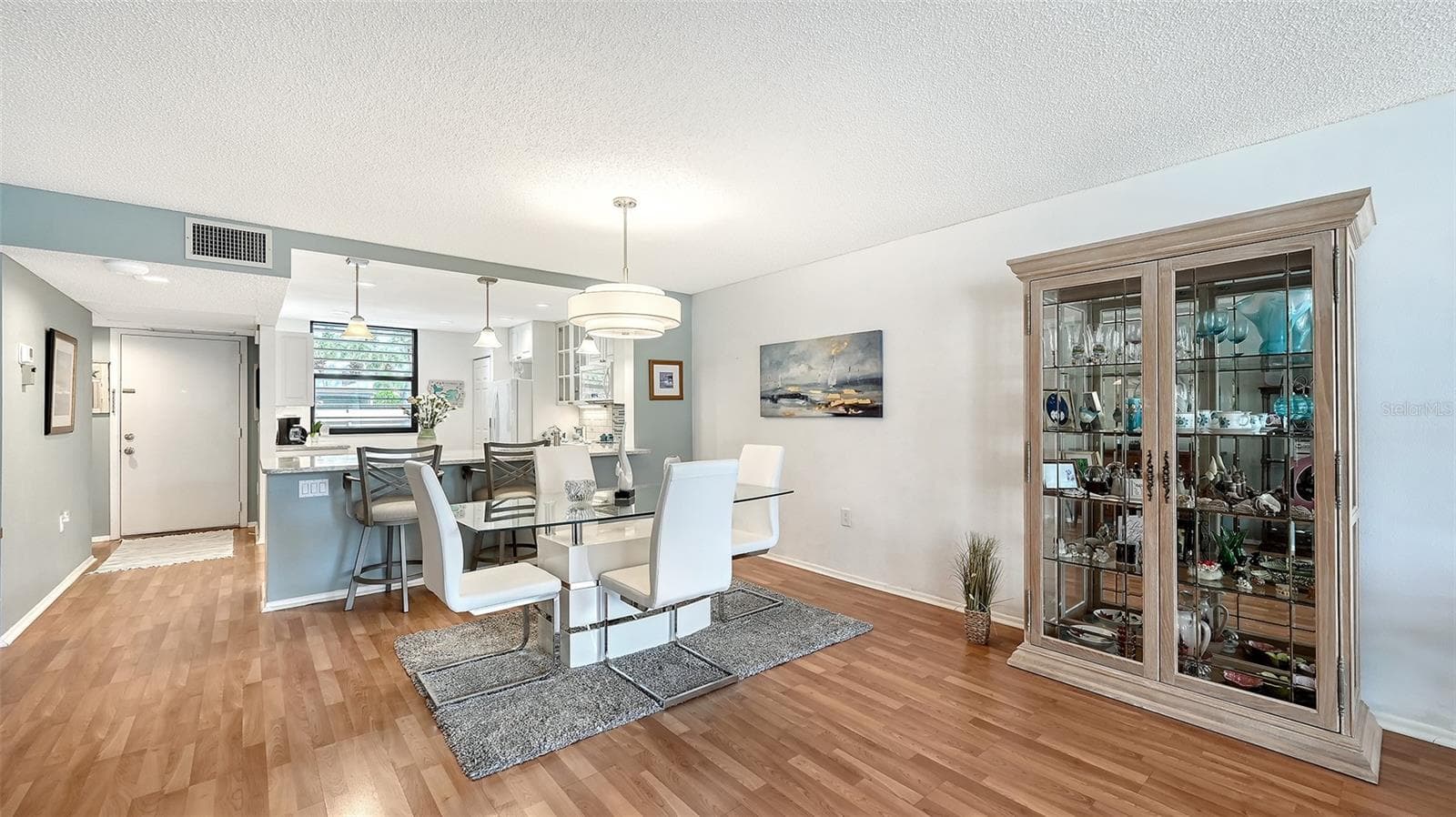 The extension of the living area into the lanai creates extra elbow room in the dining room. - 666 WOODLAWN DR #666, BRADENTON