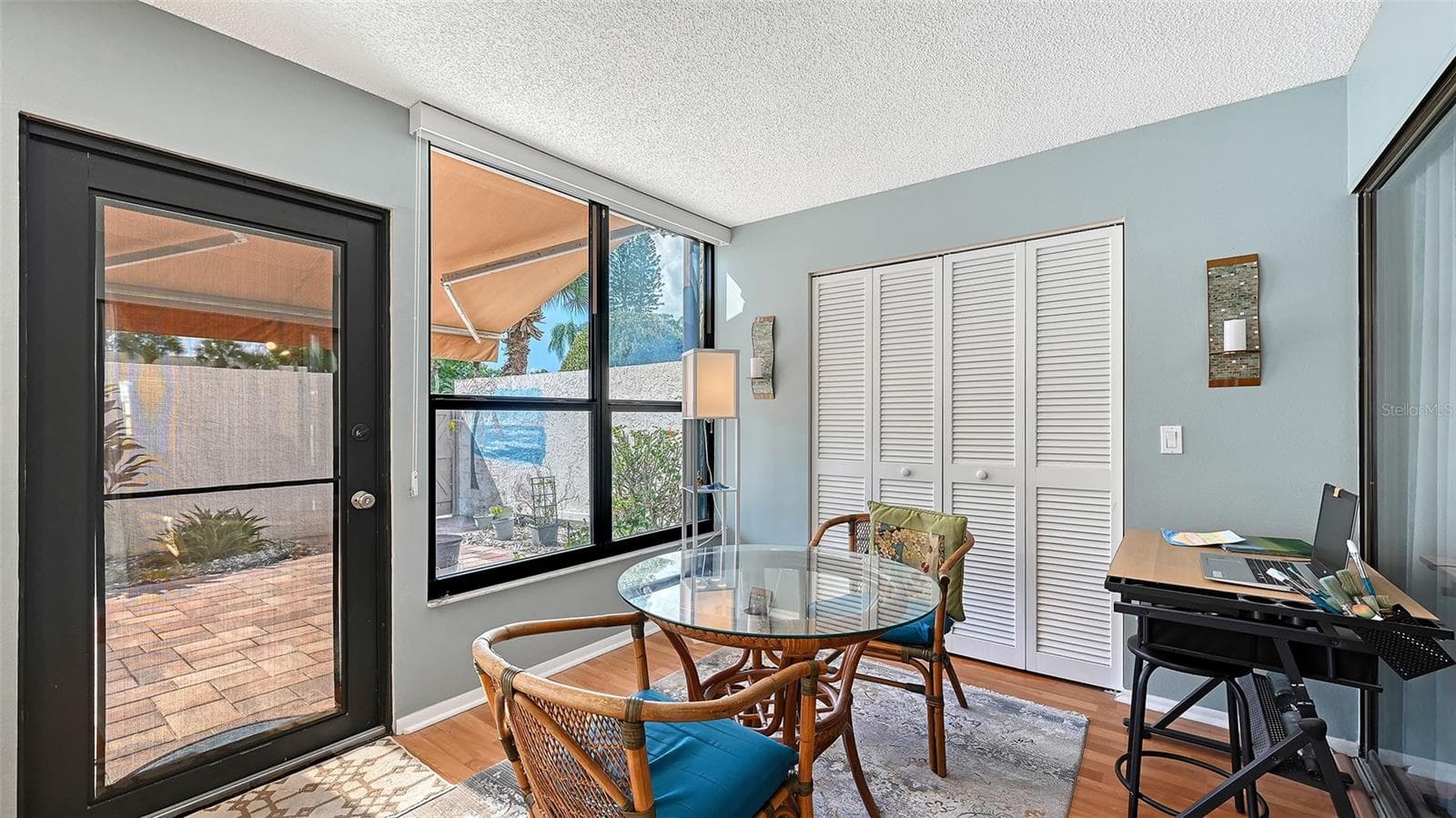 A real back door means that you won't have to wrestle with heavy sliders to access the courtyard. You can also wee the retractable shade above the door that helps keep the home cool. - 666 WOODLAWN DR #666, BRADENTON