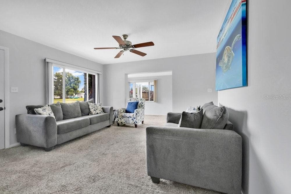 Living Room with natural light from oversized windows - 7400 36TH AVE N, ST PETERSBURG