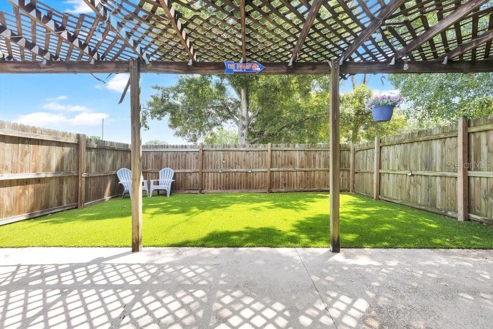 Private fenced yard area with artificial turf - 7400 36TH AVE N, ST PETERSBURG
