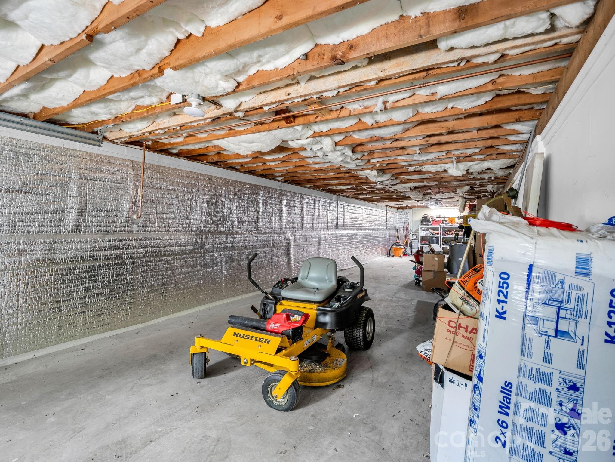 Parking side of basement has had moisture barrier installed with transferable warranty - 3208 Florida Drive, Hendersonville