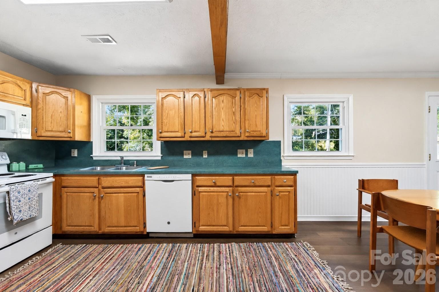 New laminate flooring in the kitchen (NOTE: ONE CABINET DOOR IS MISSING AND IN THE PROCESS OF BEING REPLACED...PHOTO EDITED TO INCLUDE DOOR) - 2 Independence Boulevard, Asheville
