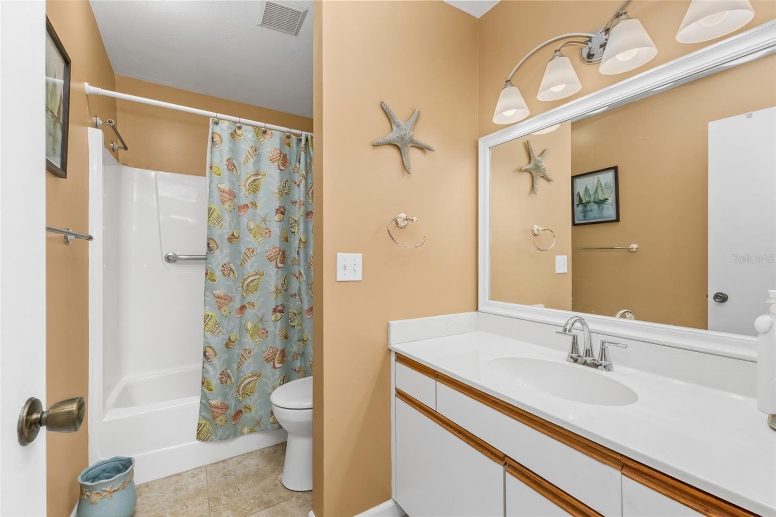 The private primary bath offers a spacious vanity with generous counter space, a large wall mirror and a tub/shower combination—all conveniently tucked within the primary suite. - 6800 PLACIDA RD #235, ENGLEWOOD
