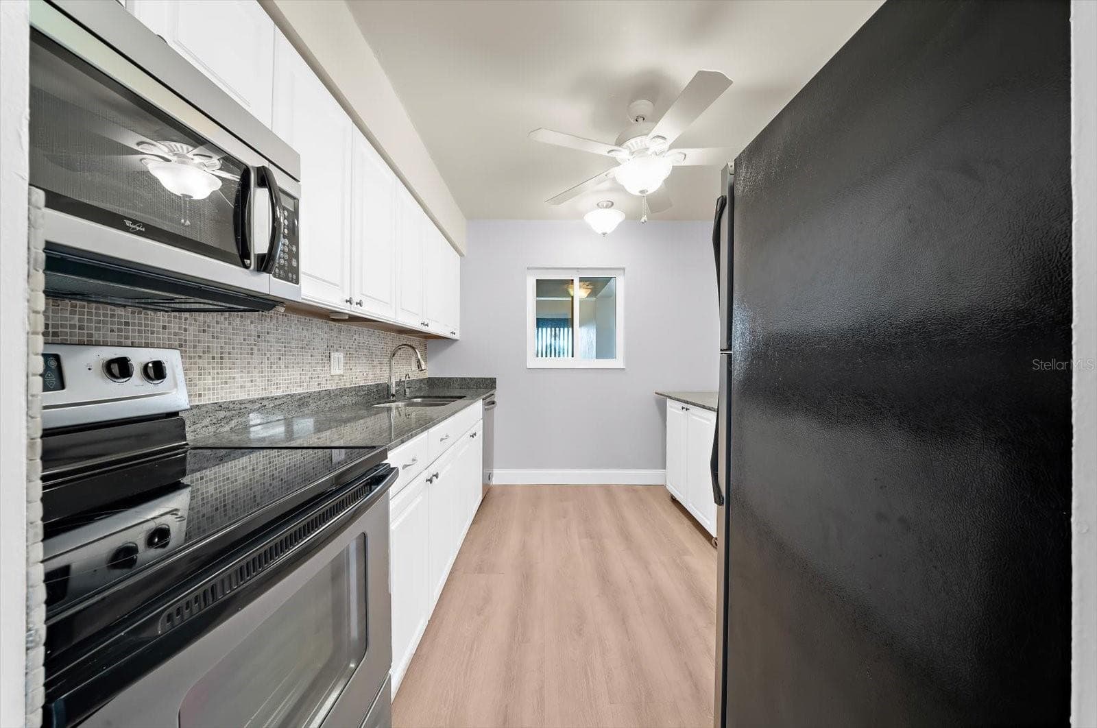 The updated kitchen offers granite counter and stainless steel appliances. - 868 BAYWAY BLVD #307, CLEARWATER BEACH