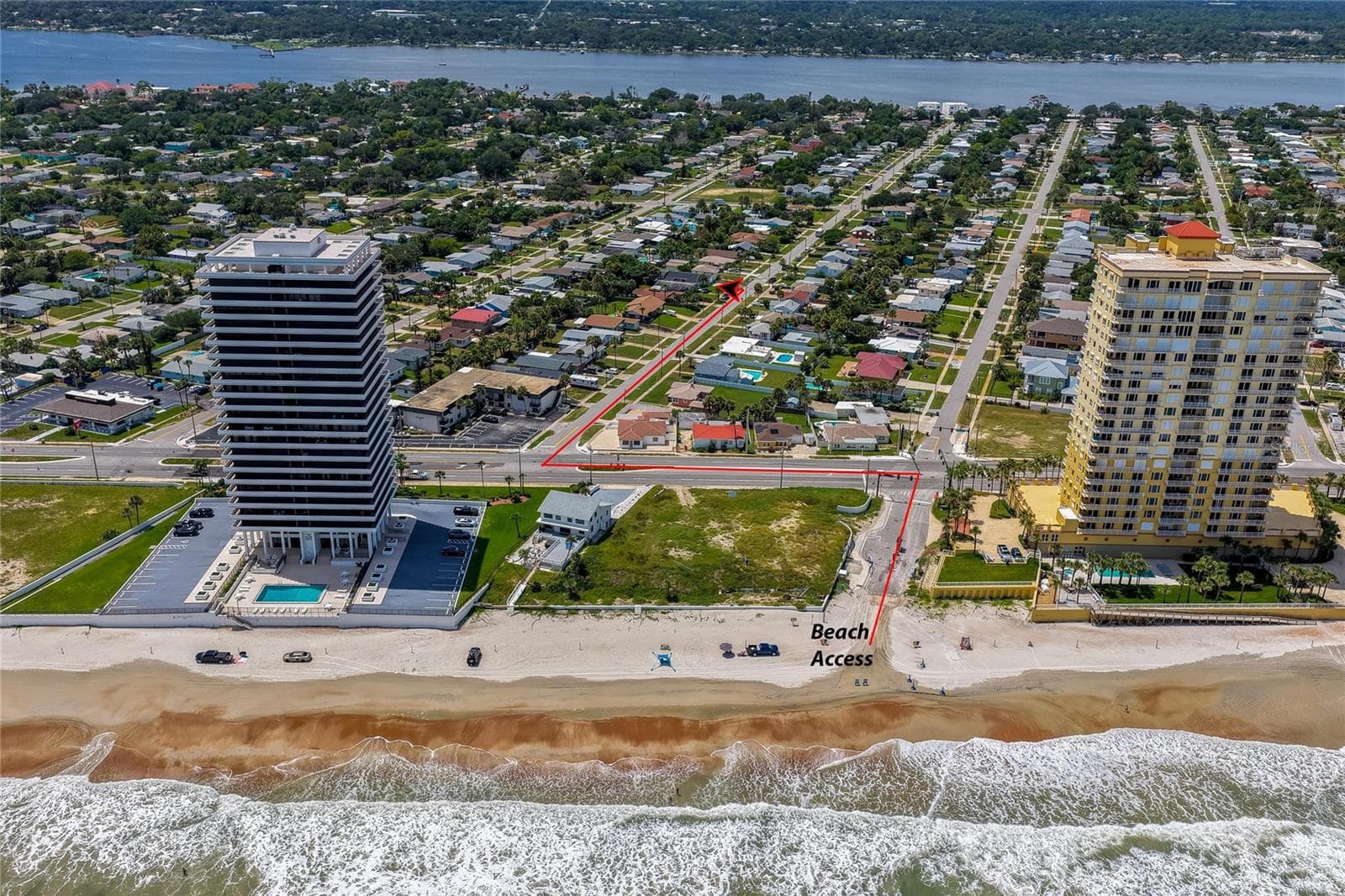 Direct ocean-facing aerial photo mapping the short, straight route from the property to the sandy beach and public beach access point. - 348 WOODLAND AVE, DAYTONA BEACH