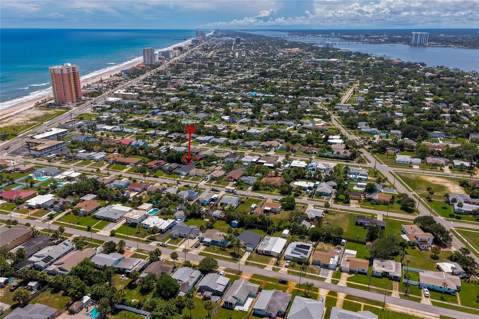 High-altitude aerial view highlighting the property within the vibrant coastal community, positioned just blocks away from the ocean and riverfront. - 348 WOODLAND AVE, DAYTONA BEACH