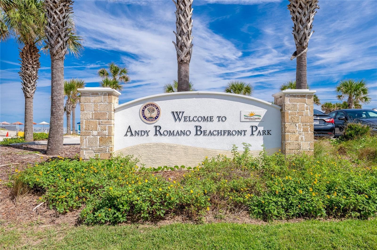 Welcoming signage identifies Andy Romano Beachfront Park, a nearby coastal recreation destination offering convenient access to the beach and Atlantic Ocean. - 348 WOODLAND AVE, DAYTONA BEACH