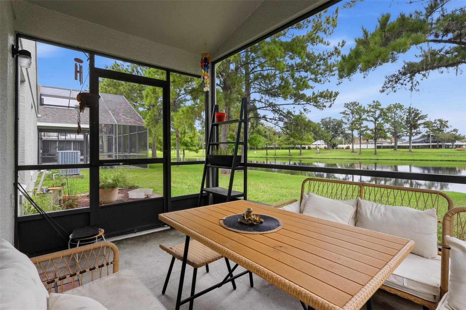 Enjoy peaceful pond views from the screened lanai, an inviting spot for morning coffee, outdoor dining or relaxing at the end of the day. - 13637 EMERALDVIEW DR, ORLANDO