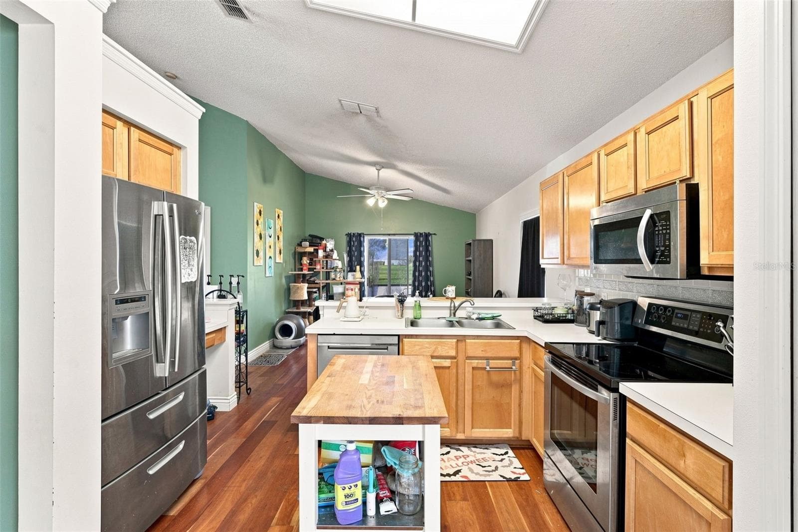 Stainless steel appliances, generous cabinetry and ample workspace make the kitchen both functional and inviting. - 13637 EMERALDVIEW DR, ORLANDO