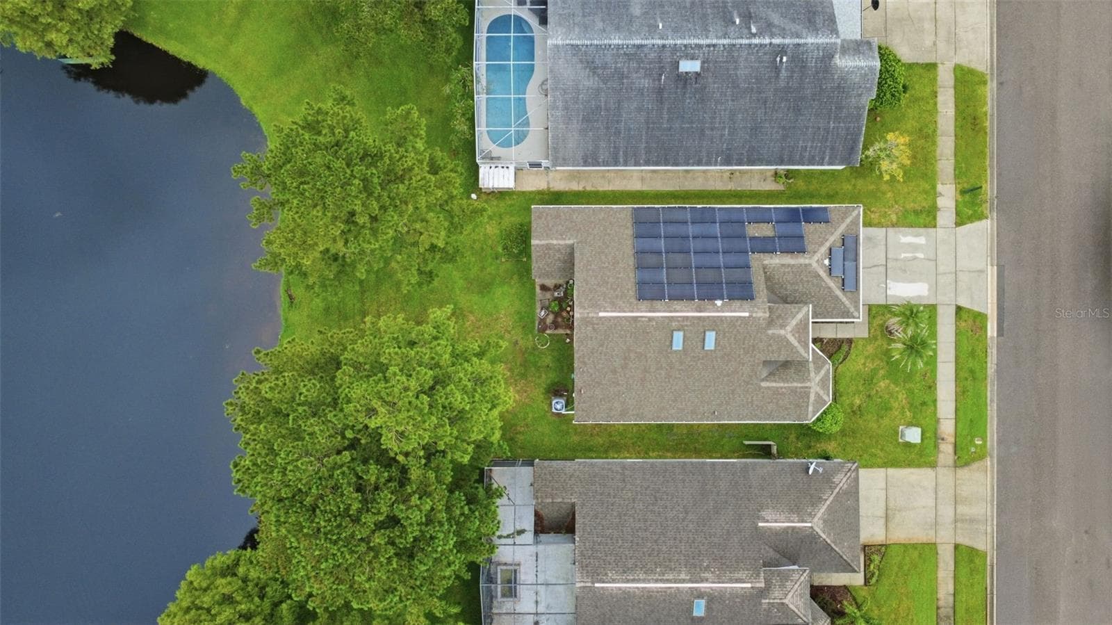 Overhead view of the property featuring the home's paid-off solar panels. - 13637 EMERALDVIEW DR, ORLANDO