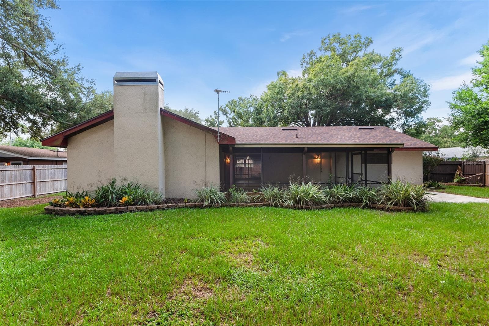Rear view of home & large screened patio - 216 SHORE LOOP, WINTER HAVEN