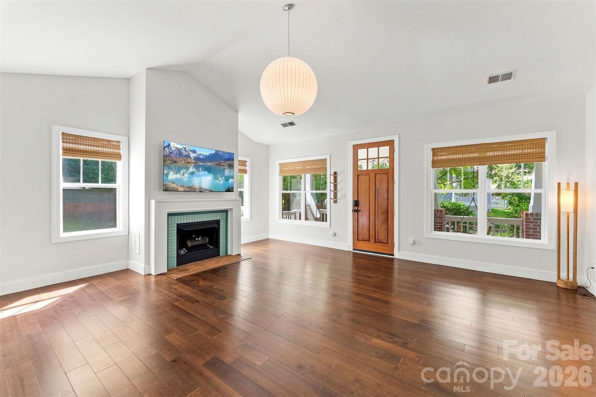 Living room with large windows overlooking the front porch - 14100 Garden District Row, Huntersville
