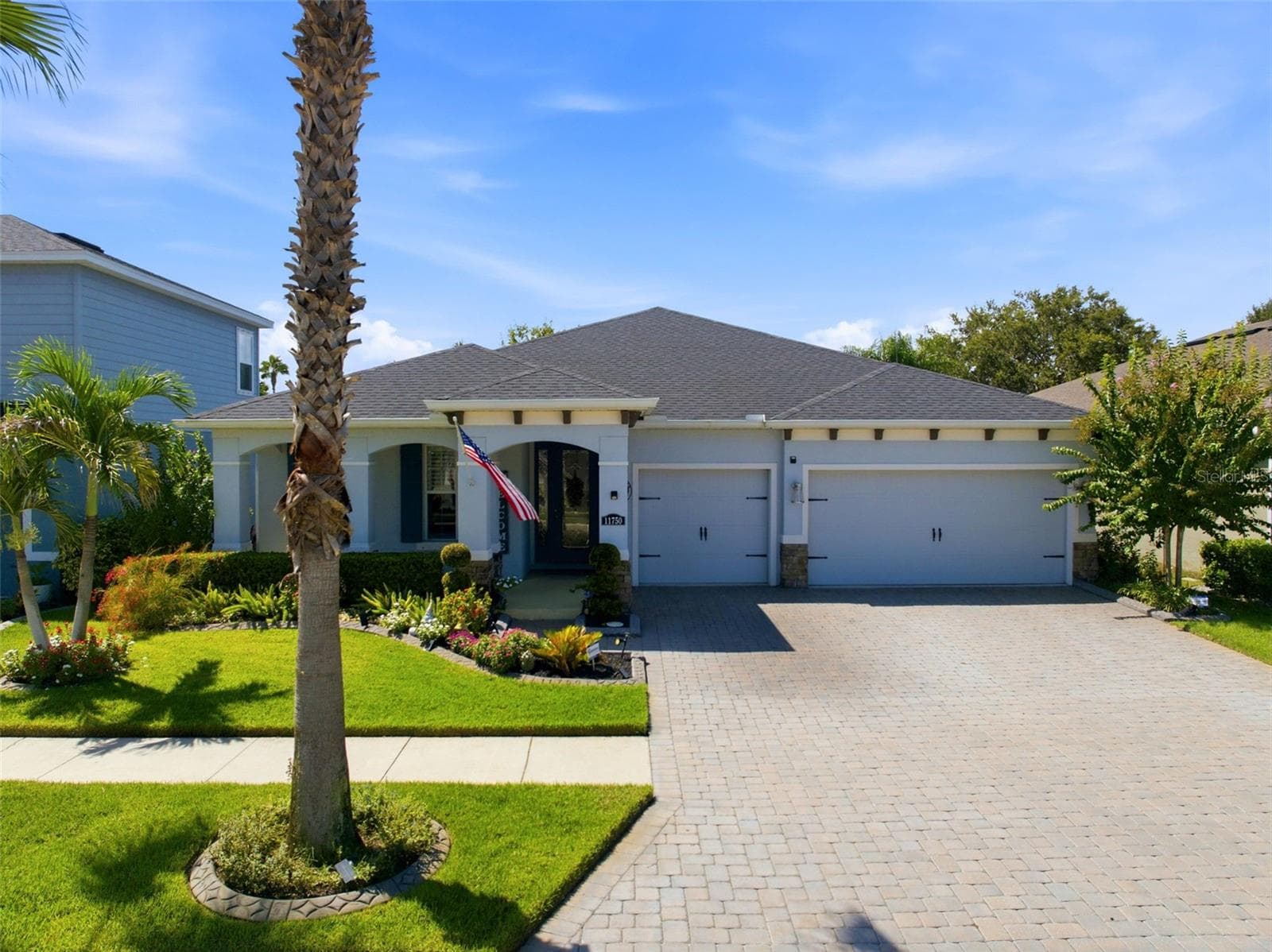 Original-owner home with a 3-car garage, paver driveway and thoughtfully upgraded landscaping. - 11750 LAKE LUCAYA DR, RIVERVIEW