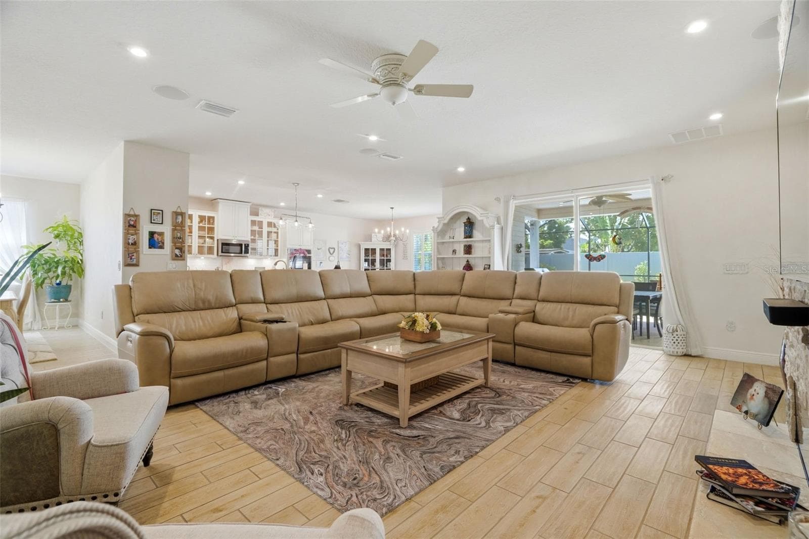 Bright, open living room with large-format tile flooring and custom interior finishes. - 11750 LAKE LUCAYA DR, RIVERVIEW