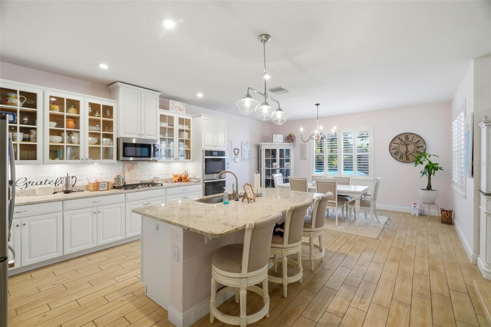 Glass-front cabinetry adds a custom touch to the kitchen design. - 11750 LAKE LUCAYA DR, RIVERVIEW