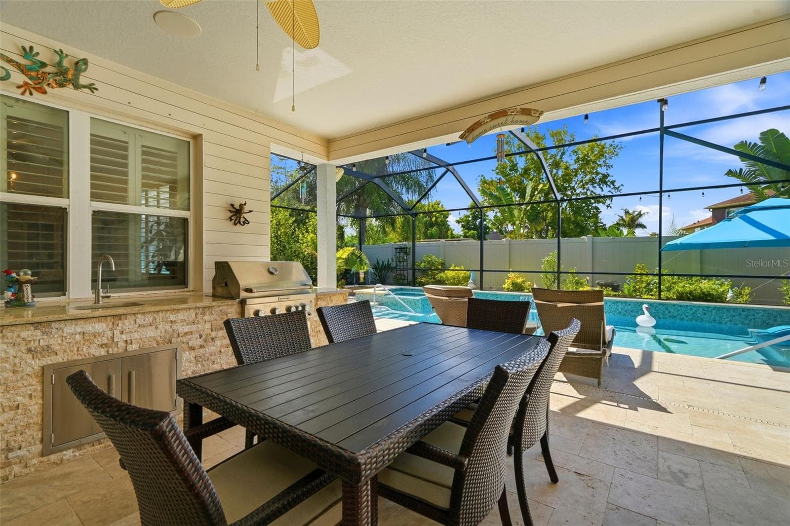 Covered lanai and custom outdoor kitchen create an ideal indoor-outdoor entertaining space. All outdoor furniture conveys. - 11750 LAKE LUCAYA DR, RIVERVIEW