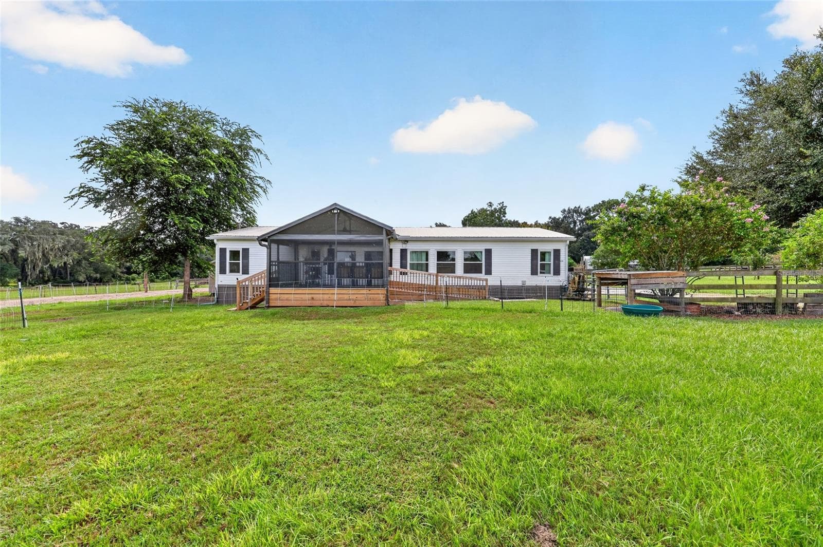 Lush paddocks in front of the stunning screened porch - 4256 SE 150TH ST, SUMMERFIELD